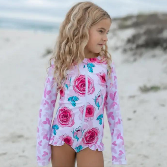 Girls pink & white rose print long sleeve one-piece zip up rash guard with ruffle detail